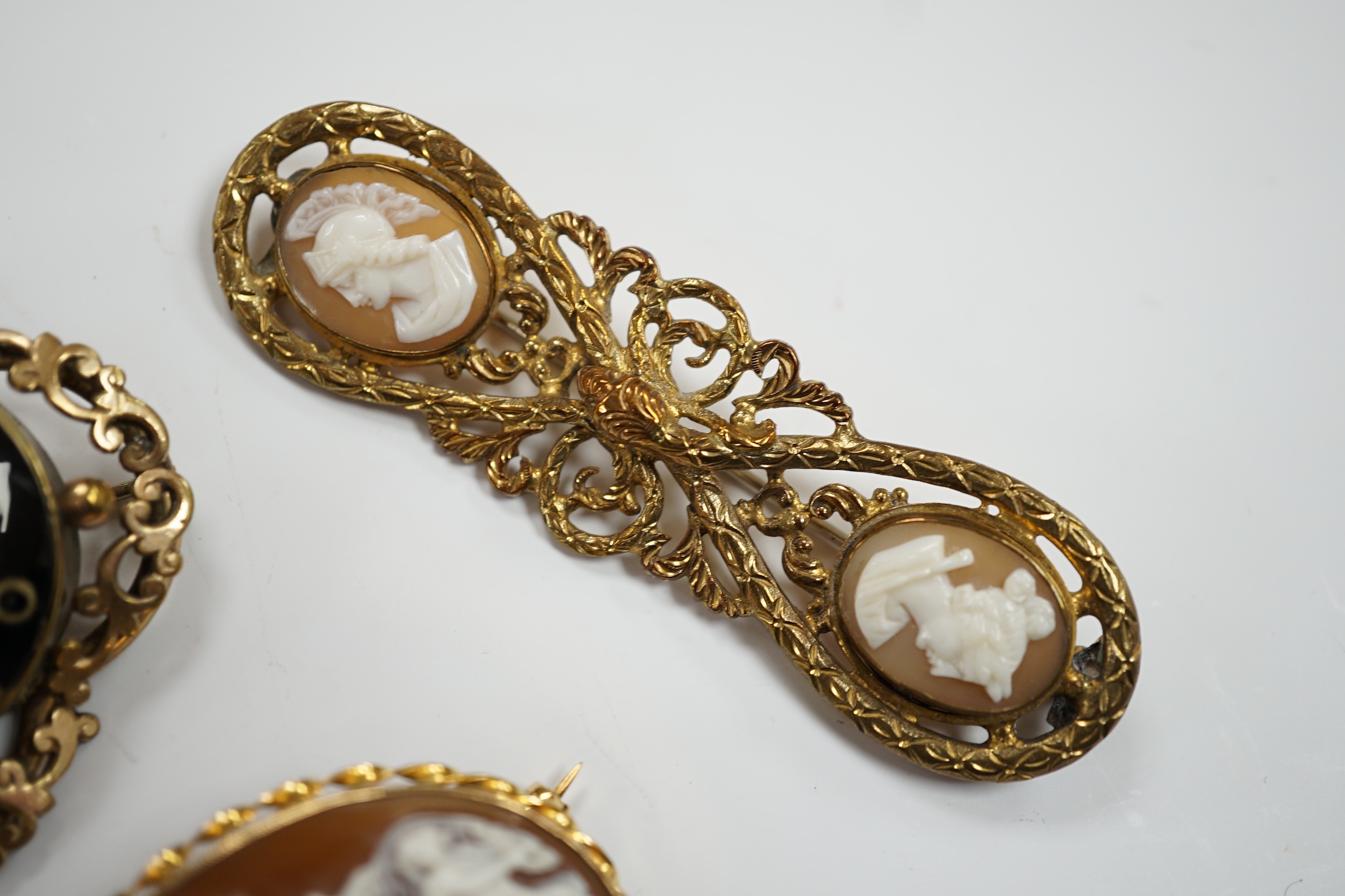 Three assorted Victorian mourning brooches, including two yellow metal, one set with seed pearls and diamond chip and inscribed and dated 1847, 48mm and two cameo shell set brooches.